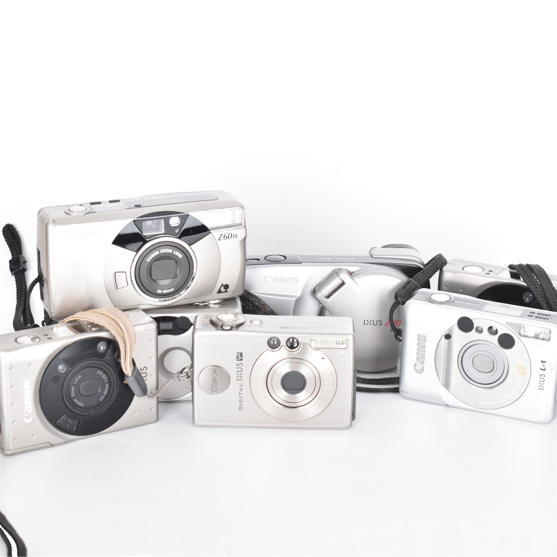 Eight Canon compact Ixus cameras, to include two Ixus examples serial nos. 2309147 & 2273184, Ixus M-1 serial no. 2932566, Ixus L-1 serial no. 2161988, Ixus Z90 serial no. 2201833,  Ixus X-1 serial no. 4704380, Z60IX serial no. 7474817, Ixus V2 serial no. 4431003237 and a Canon Powershot 350 digital camera serial no. H7MX00941