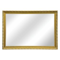 Early 20th century giltwood rectangular wall-hanging mirror, bevelled mirror plate within ...