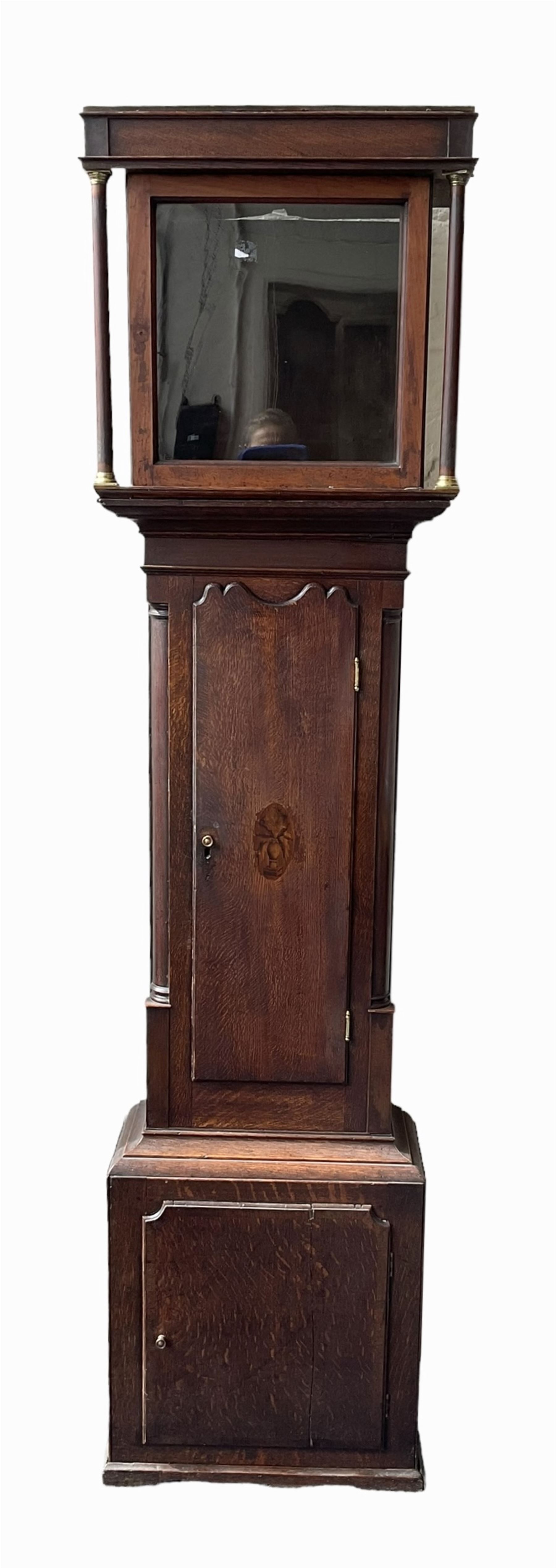 Empty oak longcase converted into a cupboard with shelves.