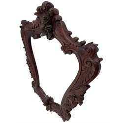 Large carved hardwood wall mirror, shaped floral carved pediment over trailing and scrolled foliage decoration, plain mirror plate 