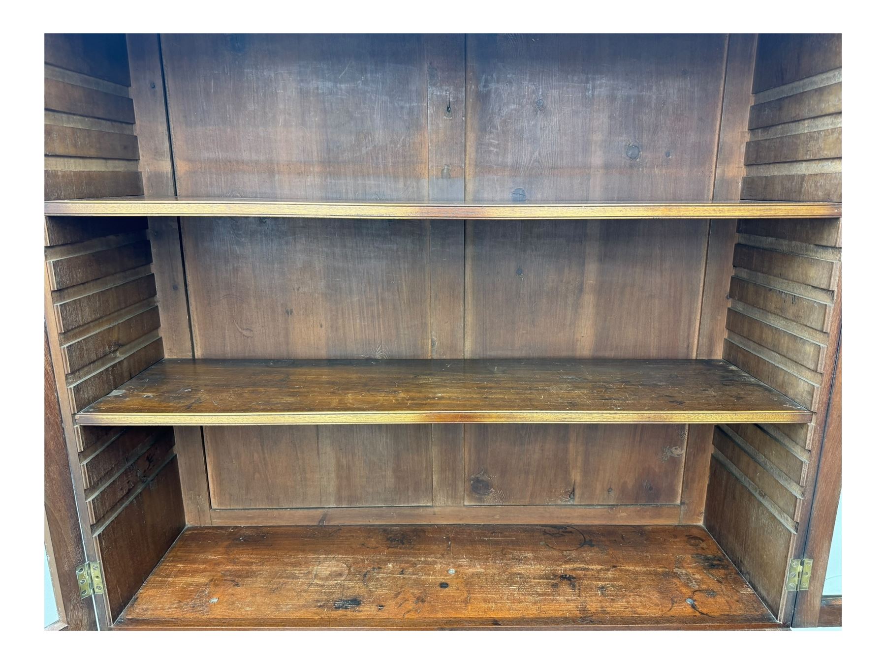 Early 19th century mahogany bureau bookcase, the projecting cornice over two Gothic-style astragal glazed doors enclosing two adjustable shelves, sloped hinged lid enclosing fitted interior and felt inset, four graduating drawers, on bracket feet