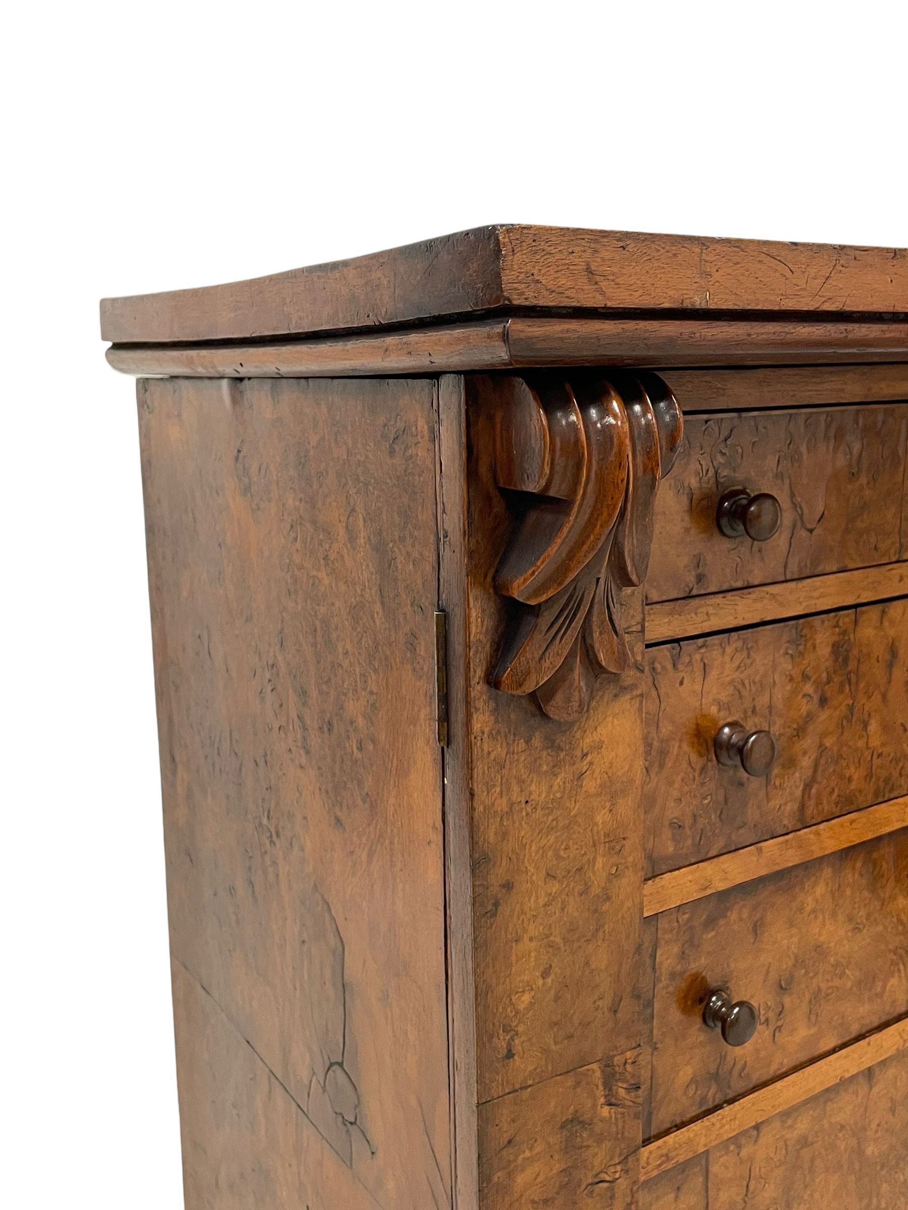 Victorian burr walnut Wellington chest, rectangular top with book-matched veneers, two hinged uprights with scrolled foliage carved brackets enclosing seven graduating drawers, on plinth base 