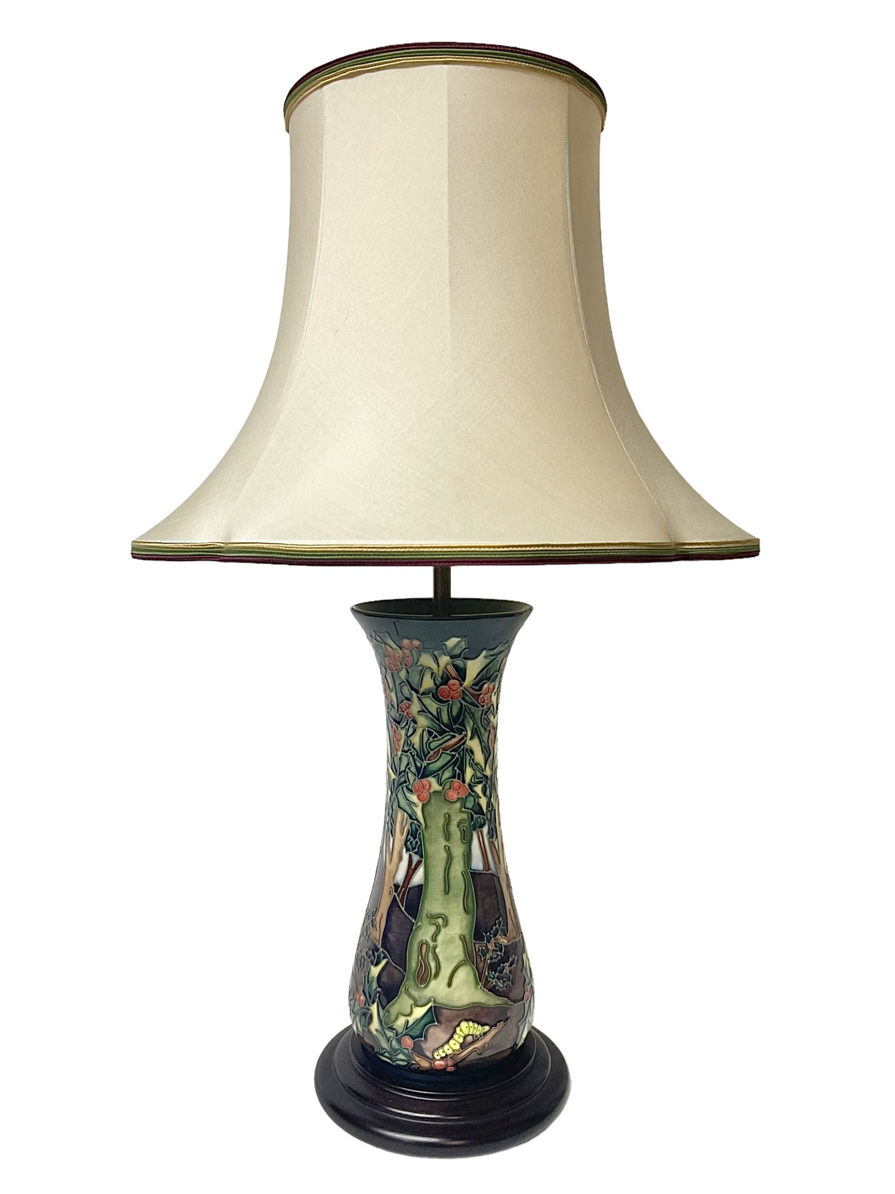 Moorcroft table lamp, of waisted form, decorated in the Holly Hatch pattern, on wooden plinth, with accompanying cream shade of lobed form, with piped detail, H33cm (excluding fitting)