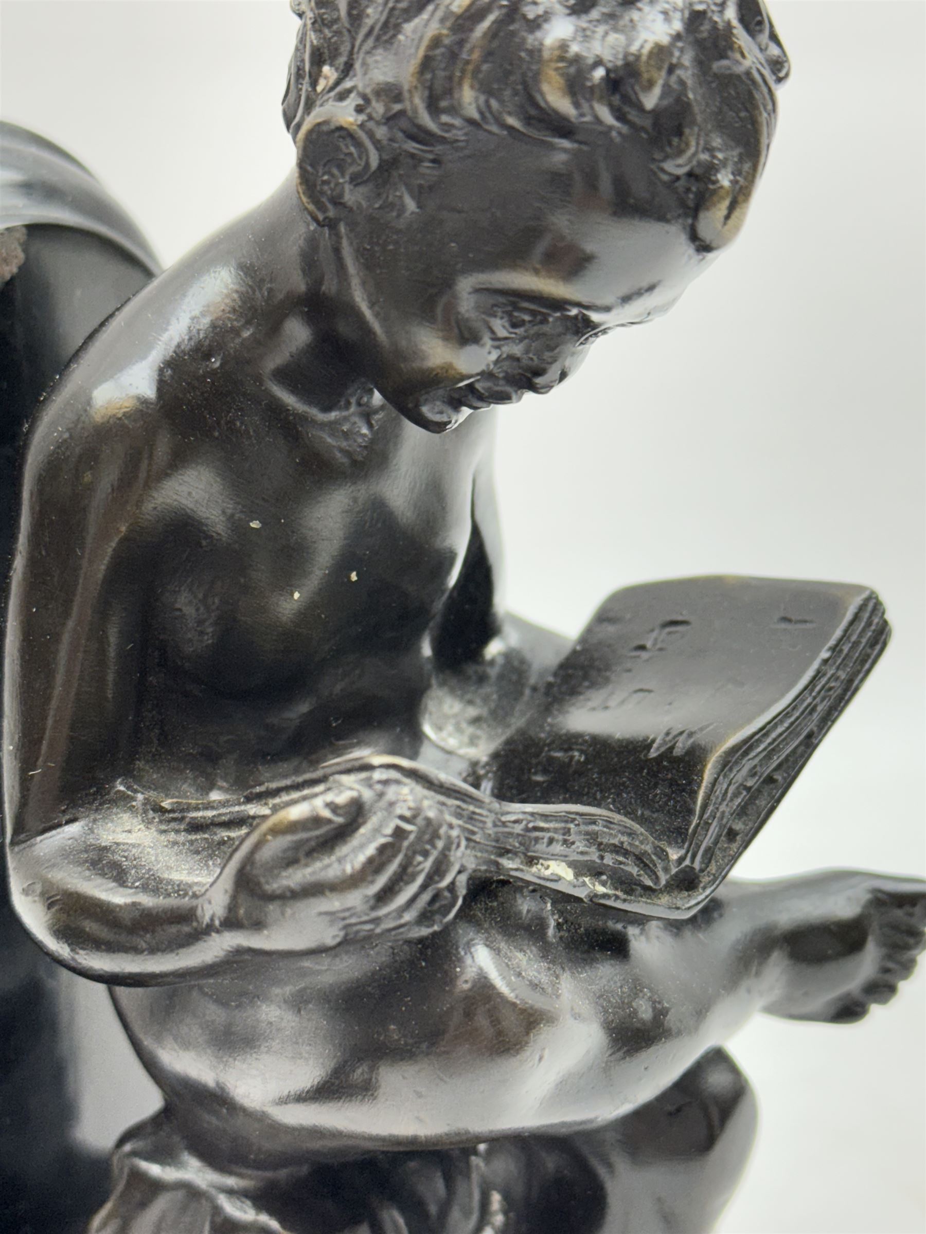 Pair of marble and bronzed bookends, modelled as putti reading, H22cm