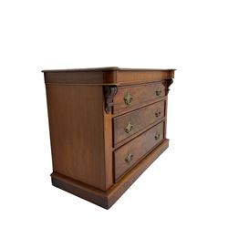 Victorian mahogany chest, shaped and moulded top over three drawers, the uprights with carved corbel mounts, on plinth base 