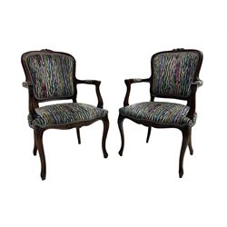 Pair of French design open armchairs, the moulded frame carved with flower heads, upholstered seat, back and arms, on cabriole supports