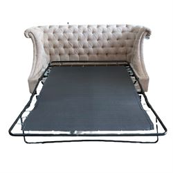 Grande wing back sofa bed, upholstered in beige buttoned fabric, metal action pull out double bed