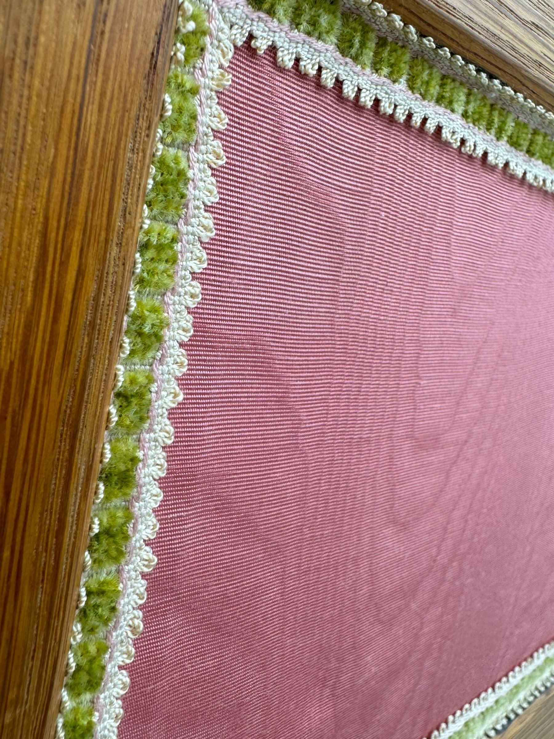 Edwardian oak and fabric folding screen, featuring three panels with oak frames, one side covered in green striped fabric with decorative trim, the reverse side in pink moiré effect fabric, connected by brass hinges