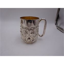 Late Victorian silver christening mug, with C handle and gilt interior, the body profusely embossed with floral and foliate decoration, hallmarked Atkin Brothers, Sheffield 1897, H10cm