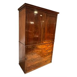 Victorian mahogany linen-press, moulded cornice over two figured panelled doors, the interior fitted with five slides and hanging rail, four long drawers below 