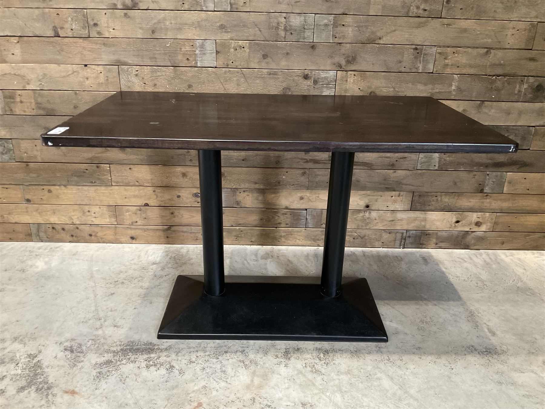 Two dark walnut rectangular console tables, on black metal bases