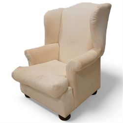 Georgian design mahogany framed wingback armchair, high shaped back over rolled arms with sprung back and seat, on compressed bun feet, upholstered in calico