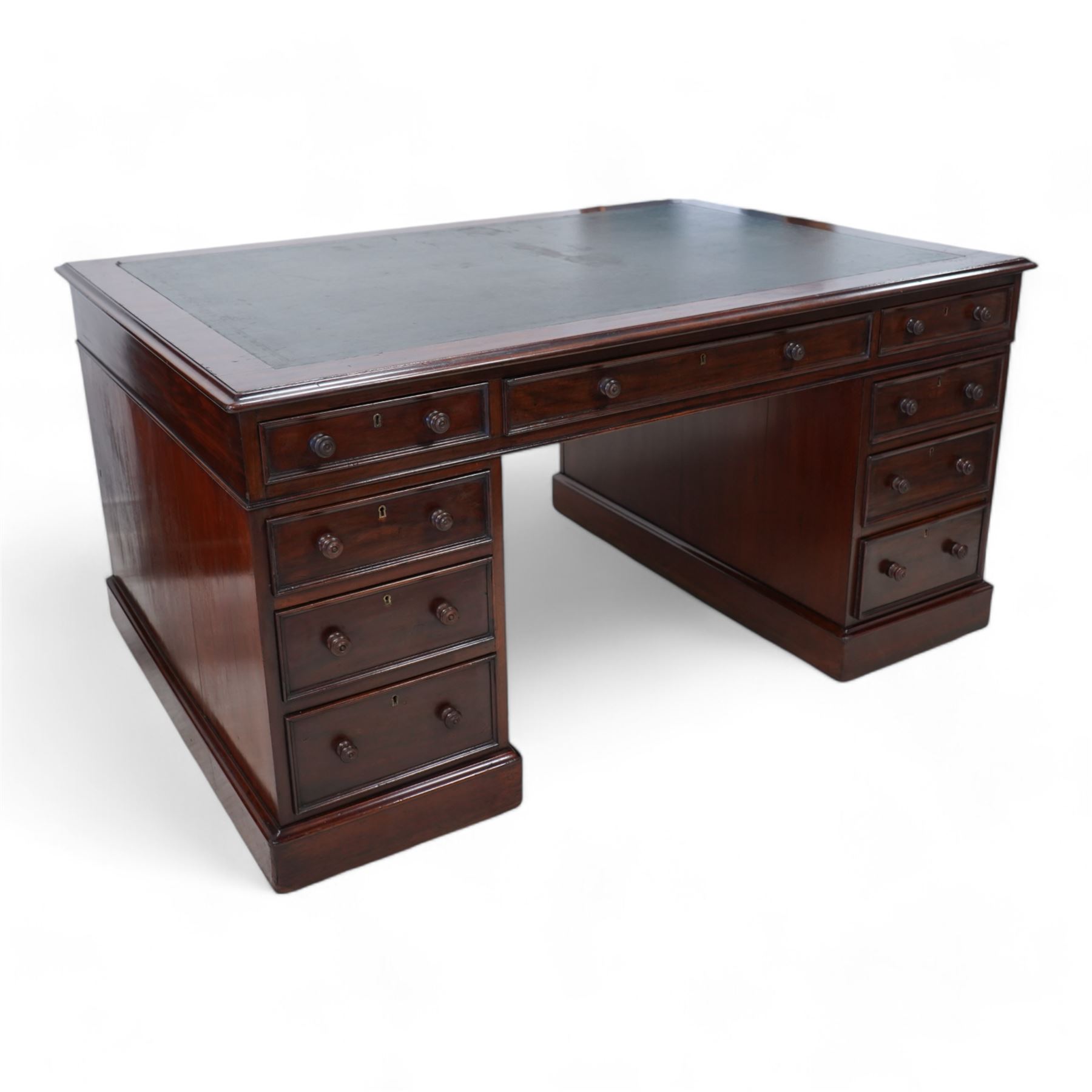 Victorian mahogany twin pedestal desk, moulded rectangular top with leather inset, one side fitted with nine drawers, the opposing side fitted with three drawers and two cupboards, two panelled doors enclosing further drawers, on moulded plinth base 