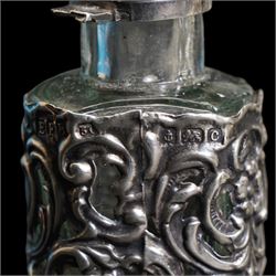 Pair of silver mounted glass scent flasks H20cm London 1916 Maker J H Worrall, Son & Co Ltd, , another matching of tapering form, a small scent flask in outer silver sleeve Birmingham 1902 and various silver mounted glass scent flasks, vases etc  (11)