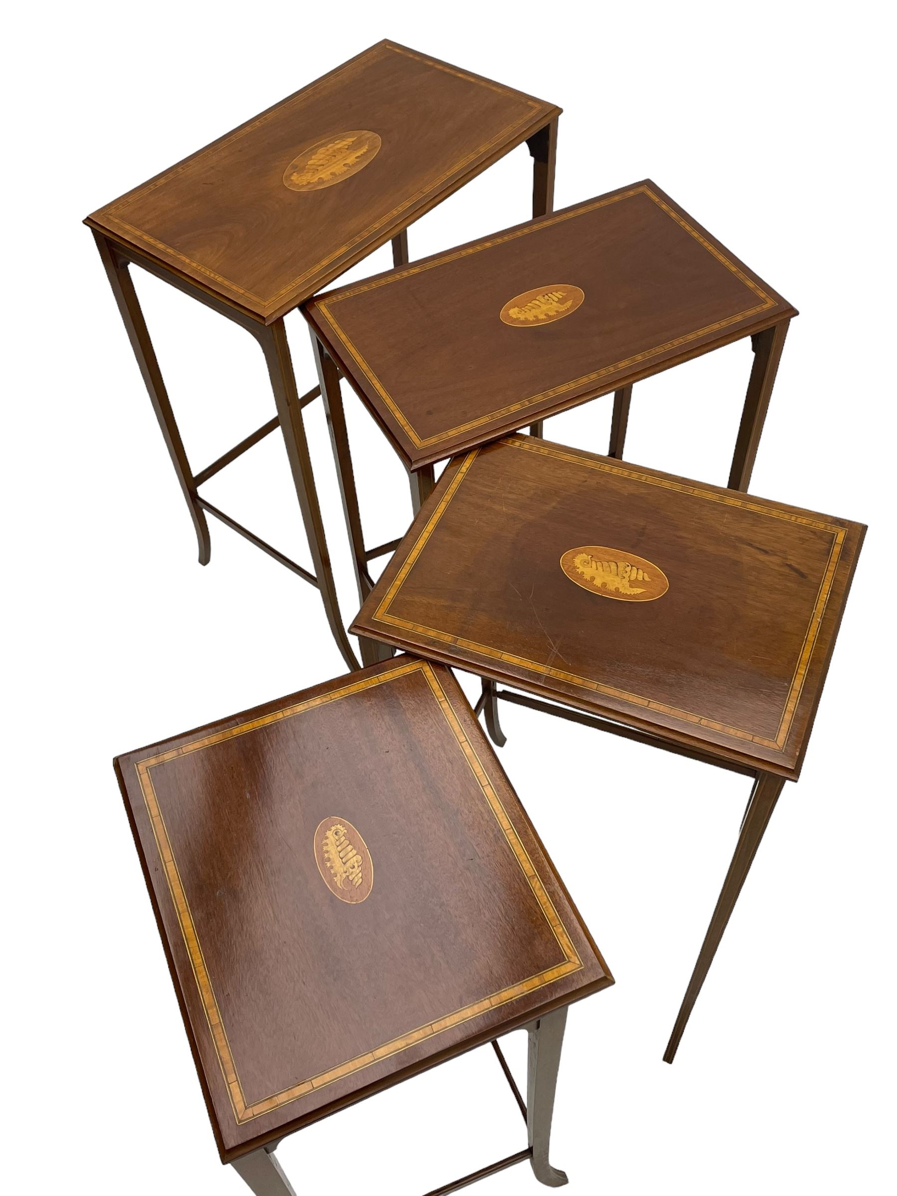 Edwardian inlaid mahogany quartetto nest of four occasional tables, each table with rectangular moulded top with satinwood band and central shell inlay, on square tapering supports with splayed terminals, inlaid with boxwood stringing