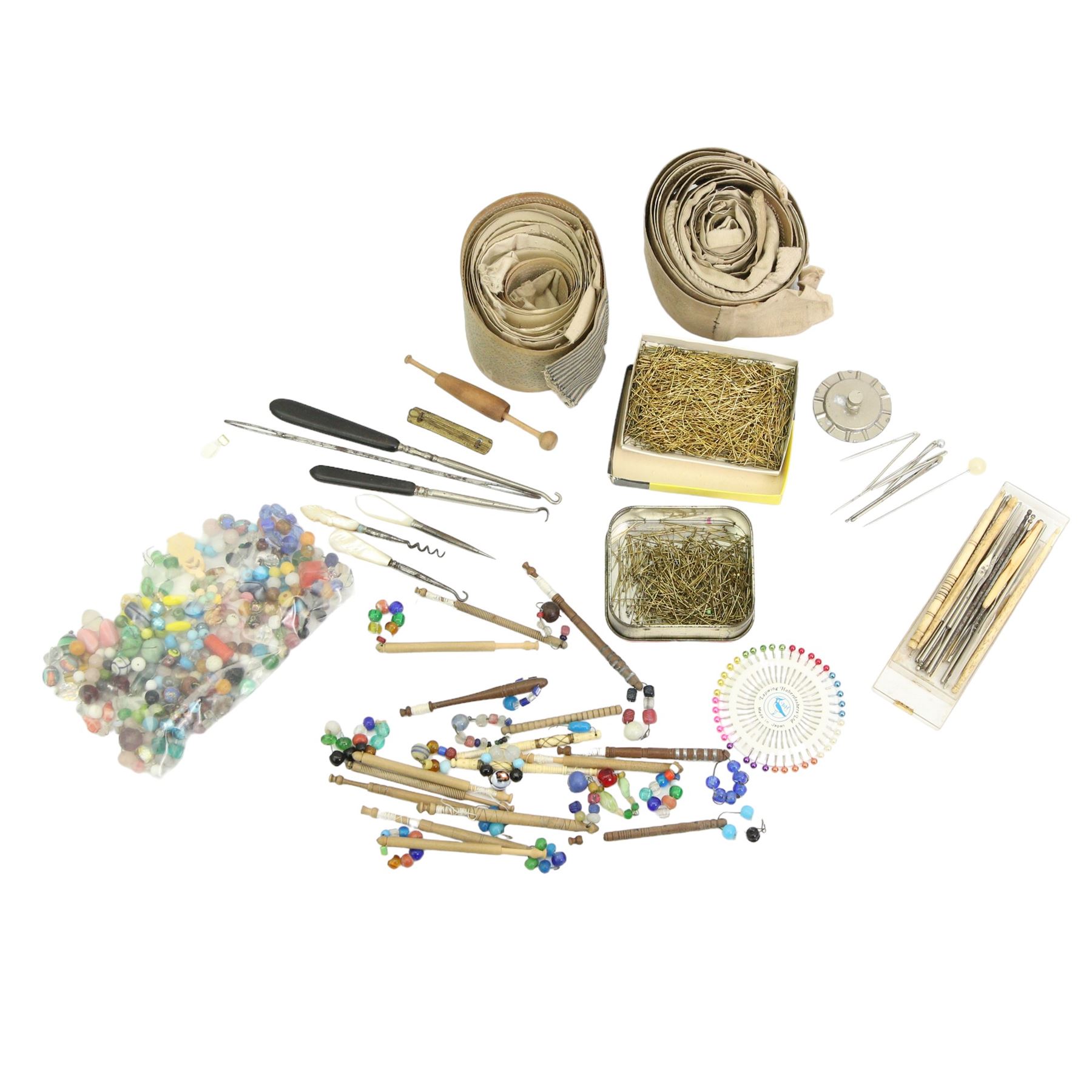 19th century and later lace maker's bone and turned wooden bobbins with glass spangles, pins, patterns, five cushions, related book and other accessories 