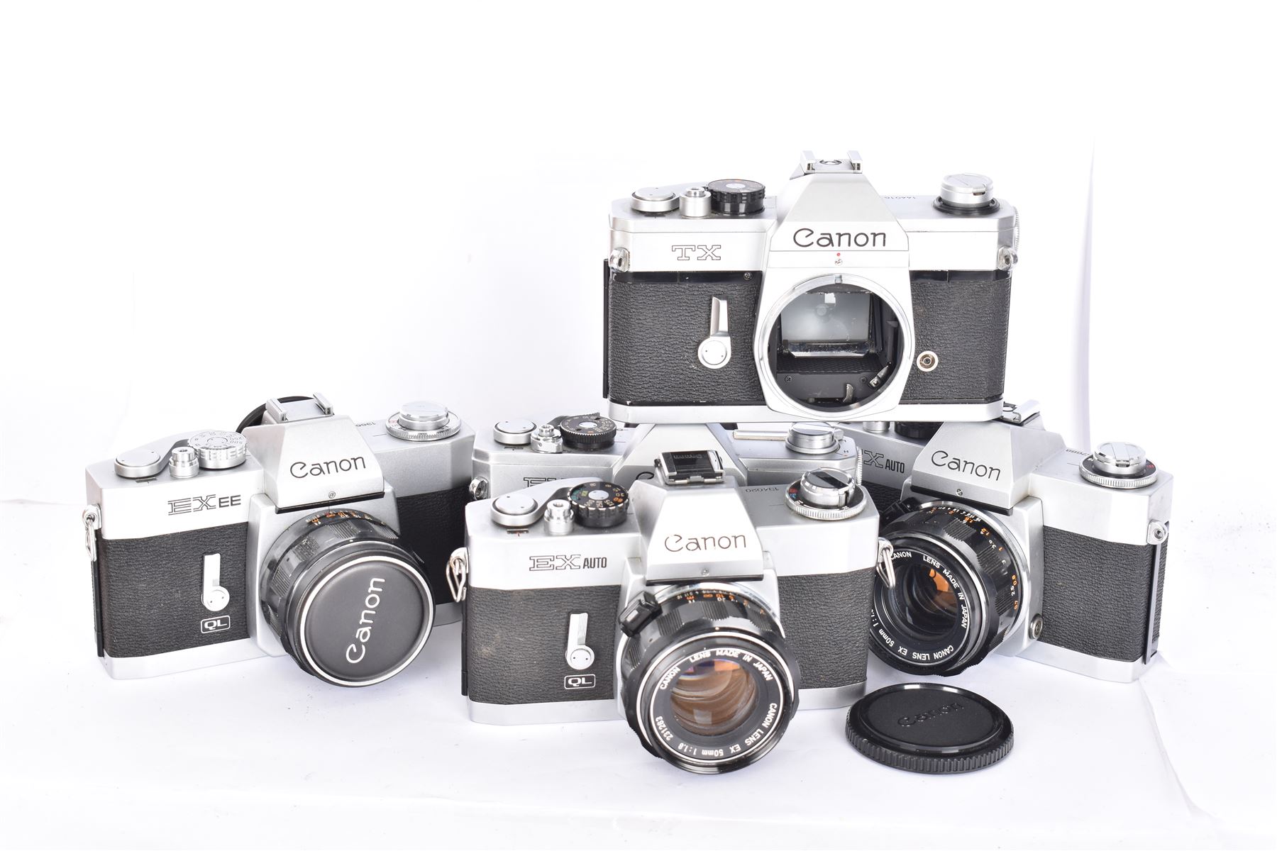 Five Canon SLR camera bodies all in silver and black finish, to include TX serial no. 144016, FX serial no. 210103, EX EE serial no. 136634 and two EX Autos, serial nos. 134020 & 157688, three with Canon 50mm 1:18 lenses