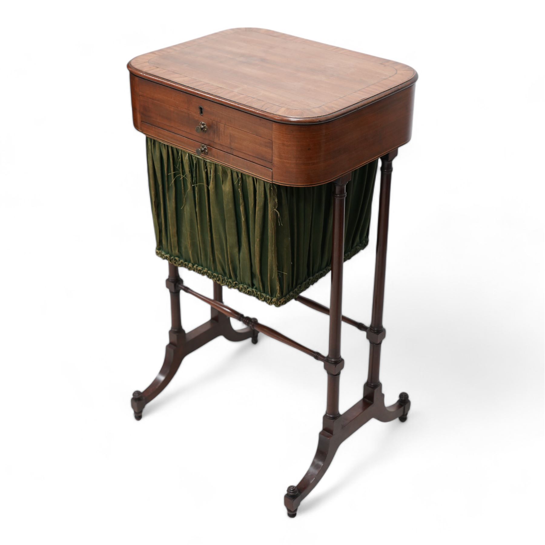 Small Regency mahogany sewing table, rectangular top with moulded edge, inlaid with cross-banding, fitted with single drawer over upholstered sliding well, raised on twin ring-turned double end supports united by two swell and ring turned stretchers, terminating to splayed supports on castors