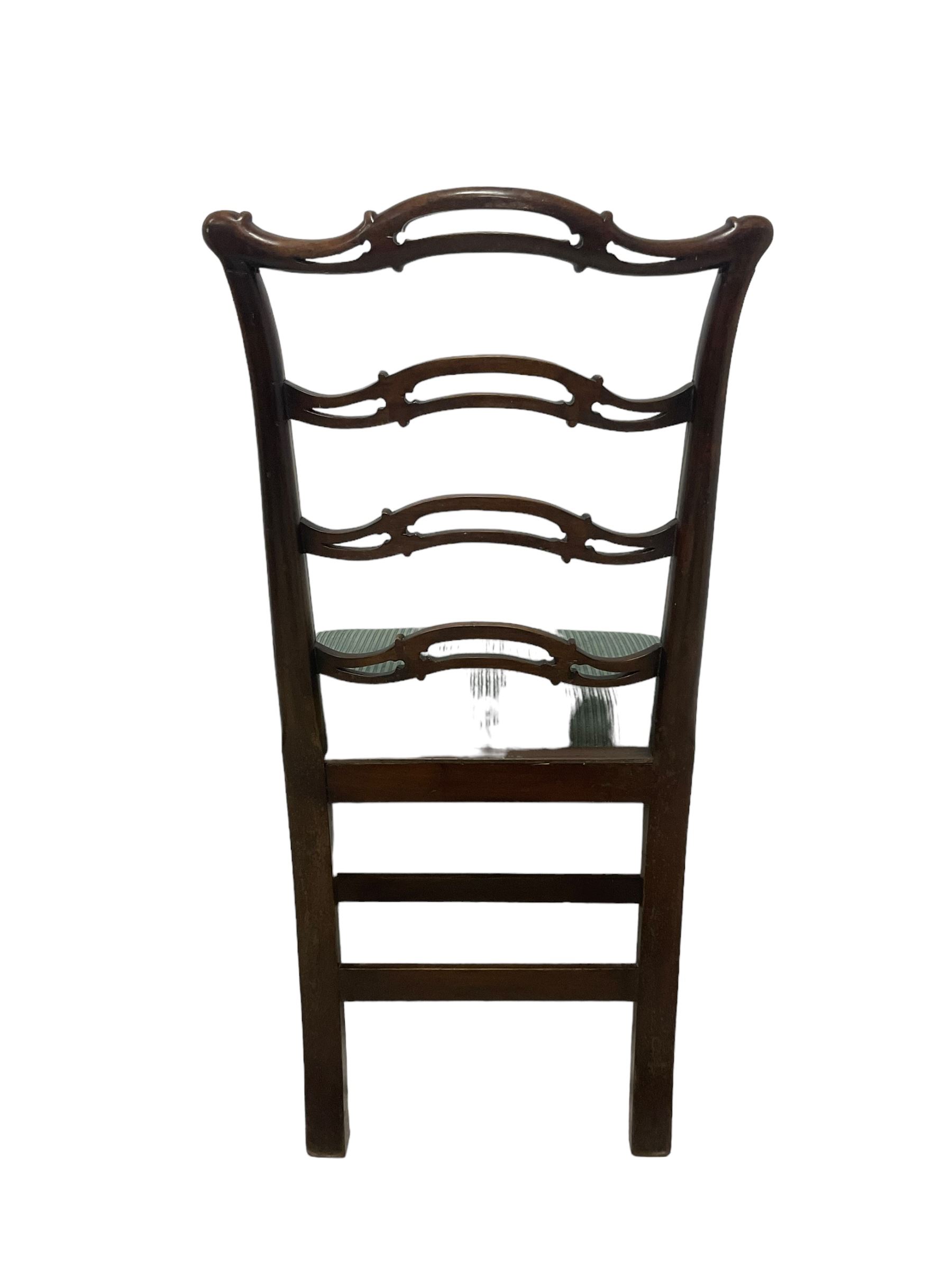 Set of twelve (10+2) Chippendale revival stained beech dining chairs, pierced waived ladder backs with over-stuffed over seats, on square moulded supports joined by stretchers