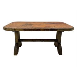 Rectangular oak coffee table, rectangular top with tan leather cover decorated with naturalistic scene, on rectangular end supports and curved feet united by turned stretcher 