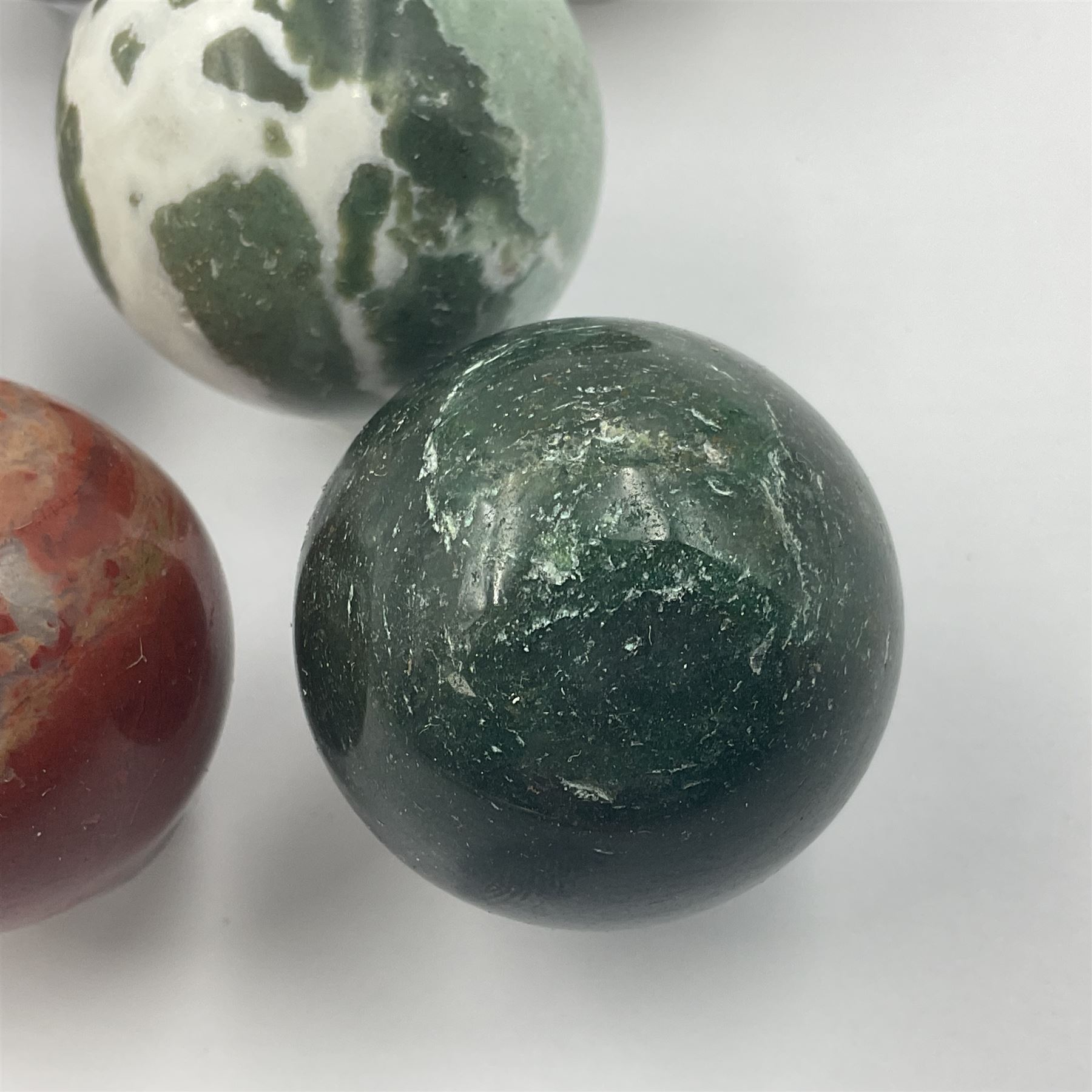 Eight mineral specimens spheres, comprising jasper red, spotted agate, unakite, sardonyx, petrified wood, Serpentine, Larvikite and green Aventurine 