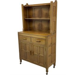 Yorkshire Oak - oak dresser, raised two heights plate rack over two drawers and double cupboard, enclosed by two panelled doors, panelled sides and back, on octagonal feet with castors 