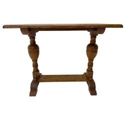 20th century oak occasional table, rectangular top on turned twin pillar supports, carved with squirrel motif, on shaped sledge feet united by stretcher 