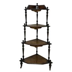 Victorian inlaid walnut corner four-tier whatnot, raised back over four graduating tiers of triangular form, decorated with satinwood and ebony inlays, united by tapering ring turned uprights, on castors