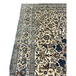 Persian ivory ground carpet, overall floral pattern with central rosette medallion, the field decorated with interlaced leafy branches and stylised plant motifs, guarded repeating border with repeating design