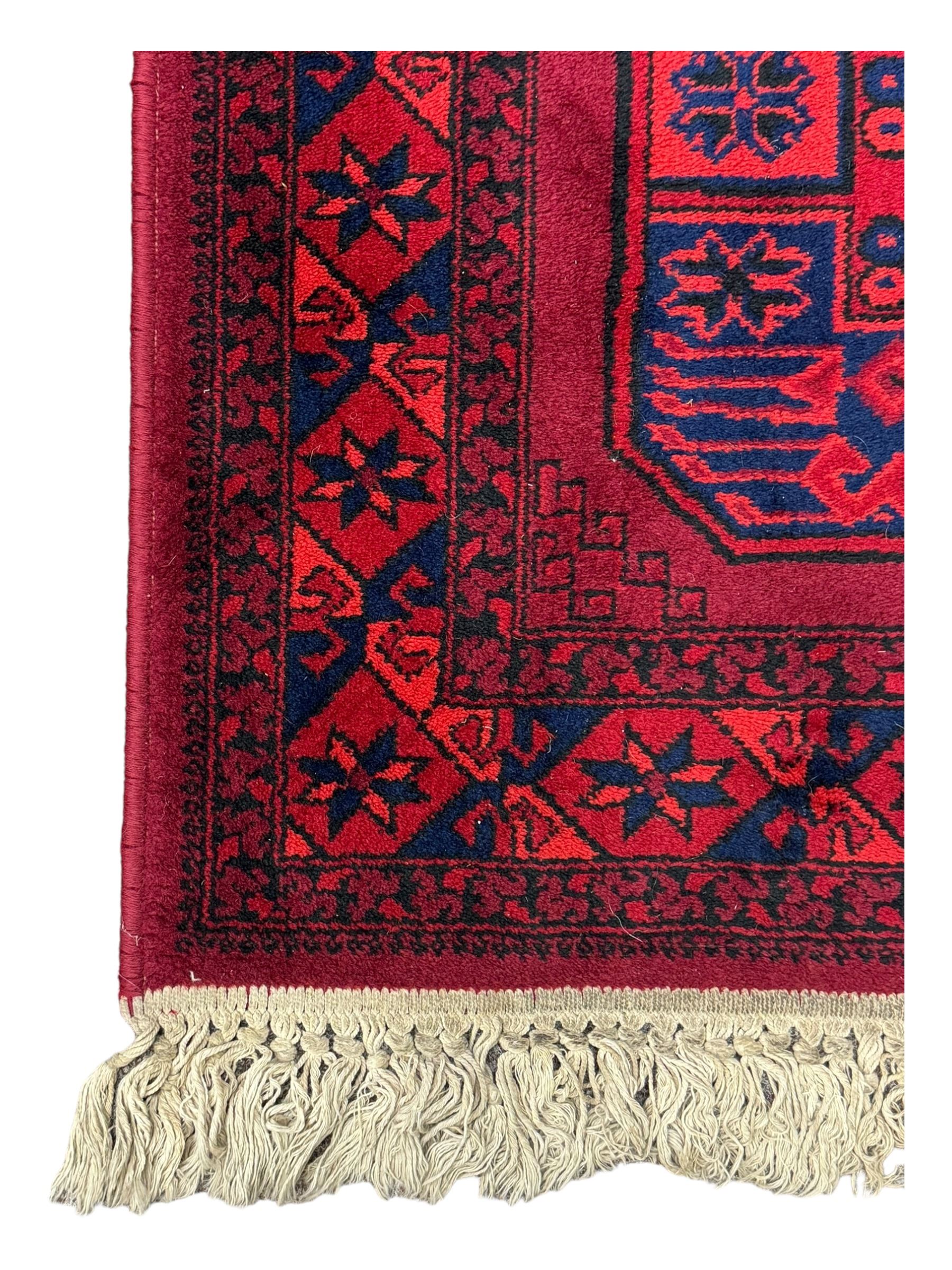 Persian Qashqai crimson ground rug, the field with central indigo and yellow medallion with geometric motifs, flanked by smaller medallions, border with repeating patterns (112cm x 200cm); Turkish Kazak light blue ground rug (109cm x 193cm); red ground runner with three octagonal medallions (69cm x 138cm)