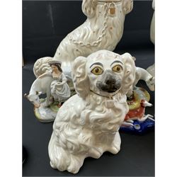 Staffordshire and Staffordshire style figures, to include a chained hound upon a blue oval base in the manner of Samuel Alcock, two pairs of seated Spaniels, a pair modelled as male figure and milk maid with cows, pair of recumbent Greyhounds, etc.