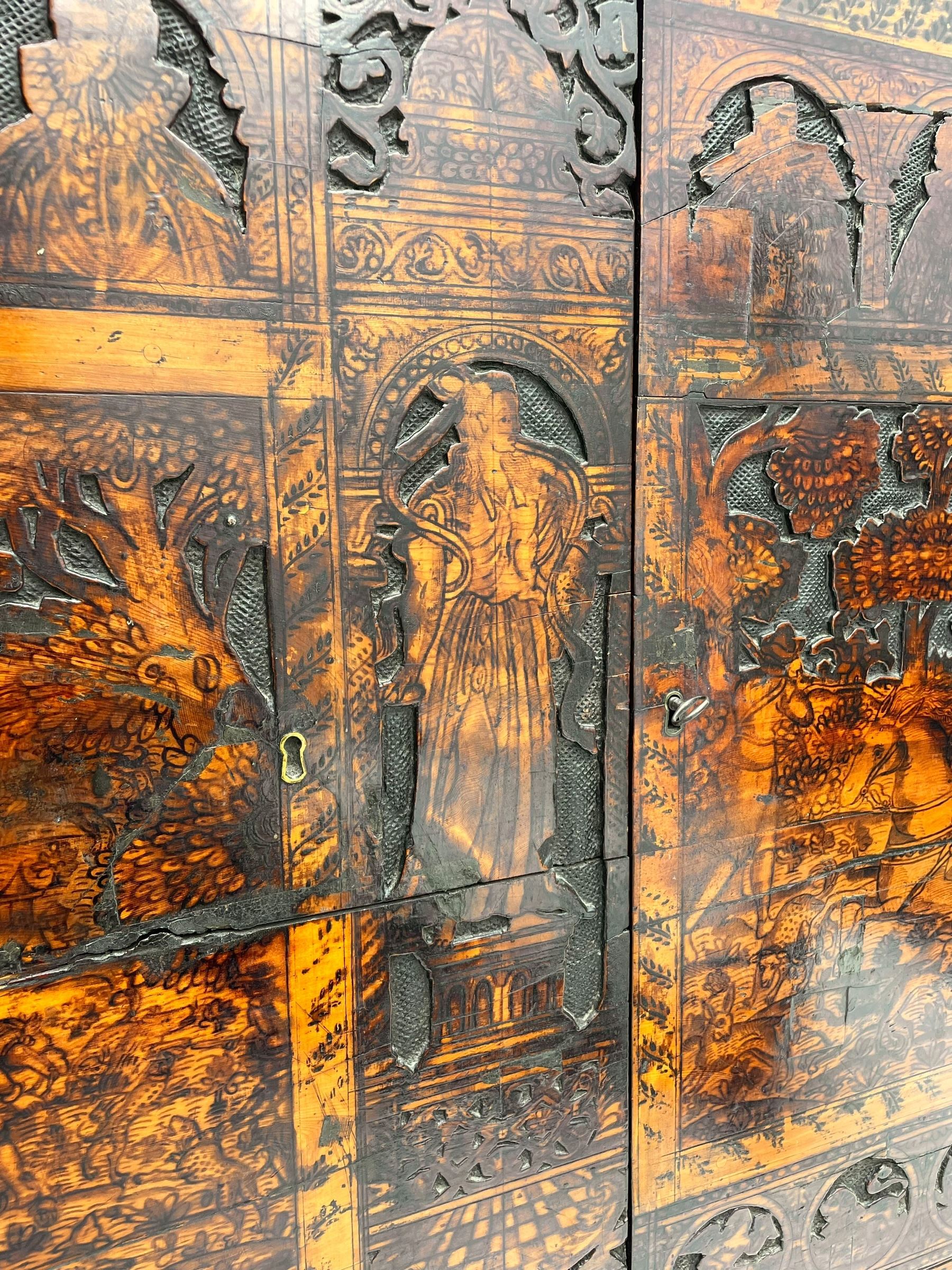 17th century and later cedarwood and pine side cupboard, moulded rectangular top, enclosed by two doors possibly removed and reused from a Venetian Cassone, carved and decorated with penwork, the upper architectural arcade with busts of noblemen, the larger decoration depicting hunters on horseback within woodland landscape with various animals, central and flanking uprights decorated with classical female figures upon pedestals, lower roundels decorated with lion and putto motifs, overall foliate decoration, raised on five hairy paw carved feet, the interior fitted with shelf