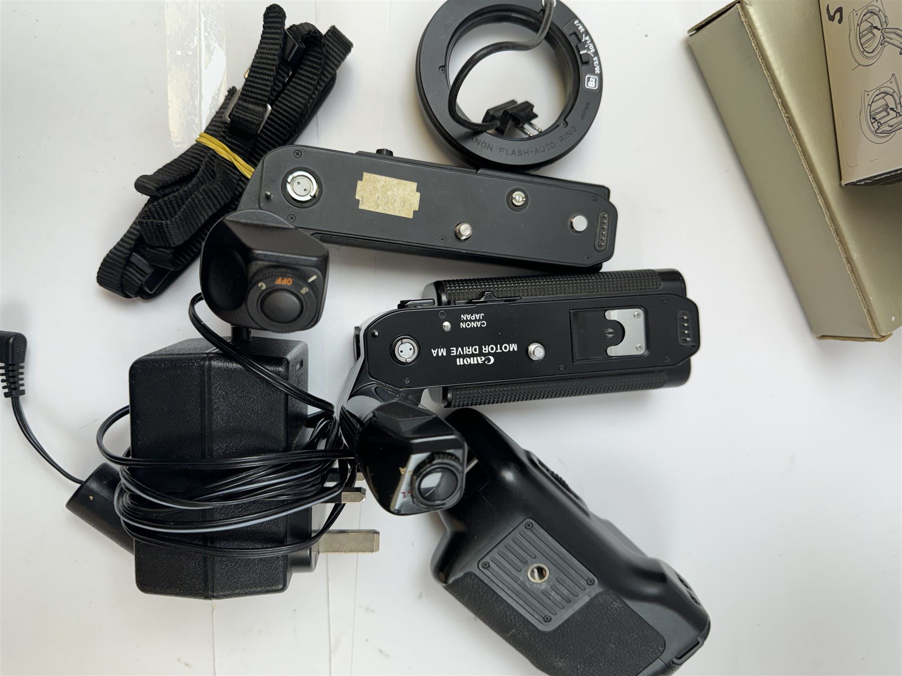 Collection of Canon camera accessories, predominantly for SLR cameras, including flashes, motor drives, quartz date back grips, filters, etc, mostly boxed or cased 