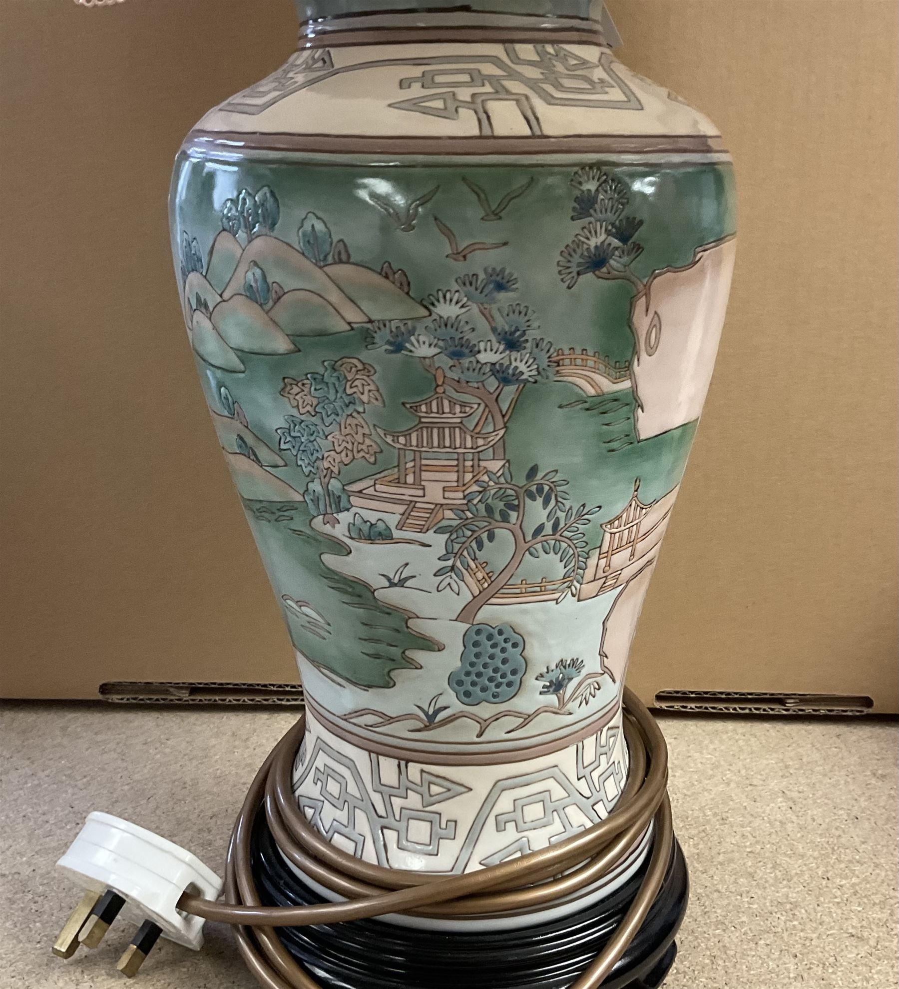 Oriental style table lamp, of baluster form, decorated with landscape scenes, with fabric shade, overall H70cm