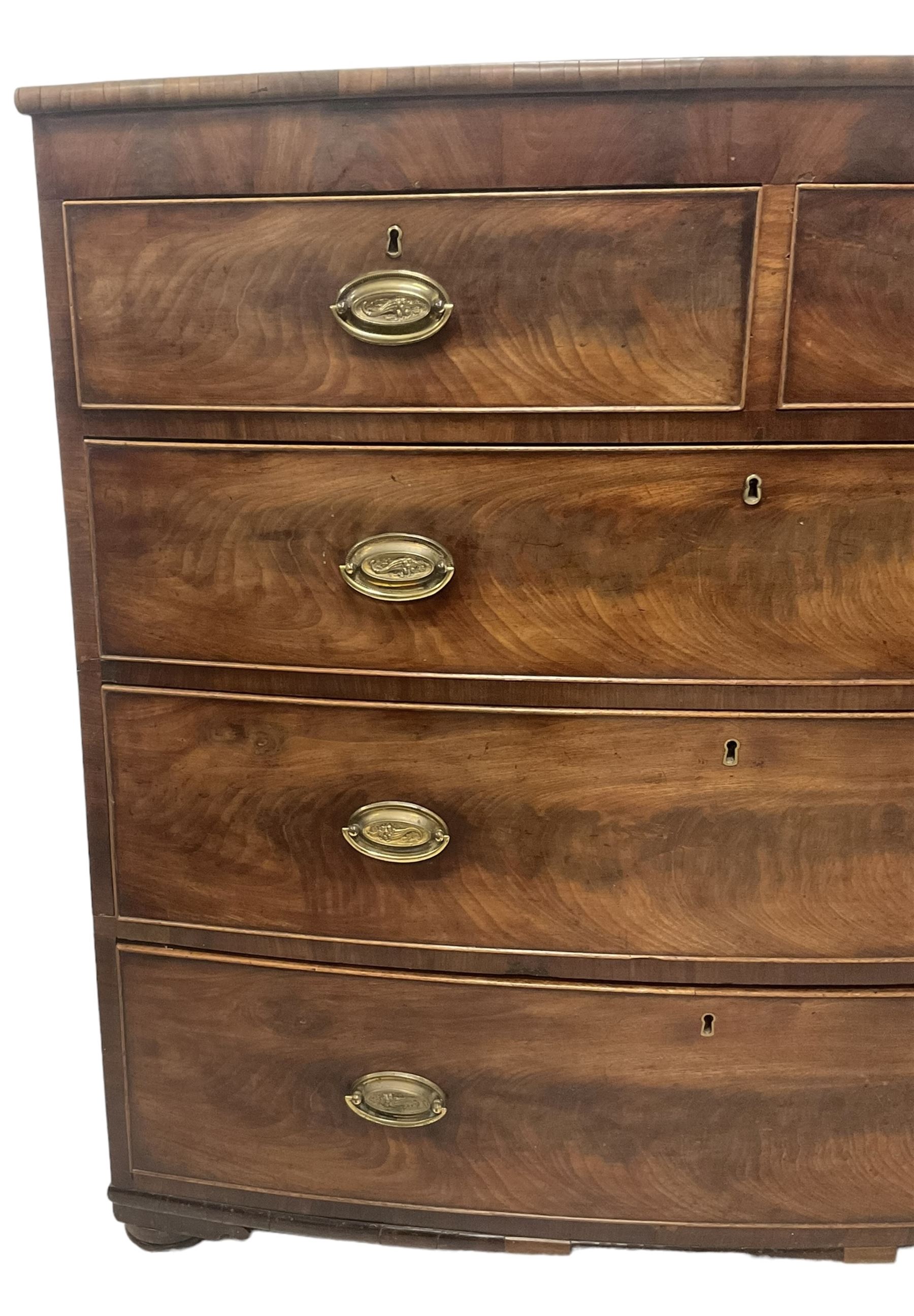 George III mahogany bow-front chest, fitted with two short over three long graduating cock-beaded drawers, on compressed bun feet