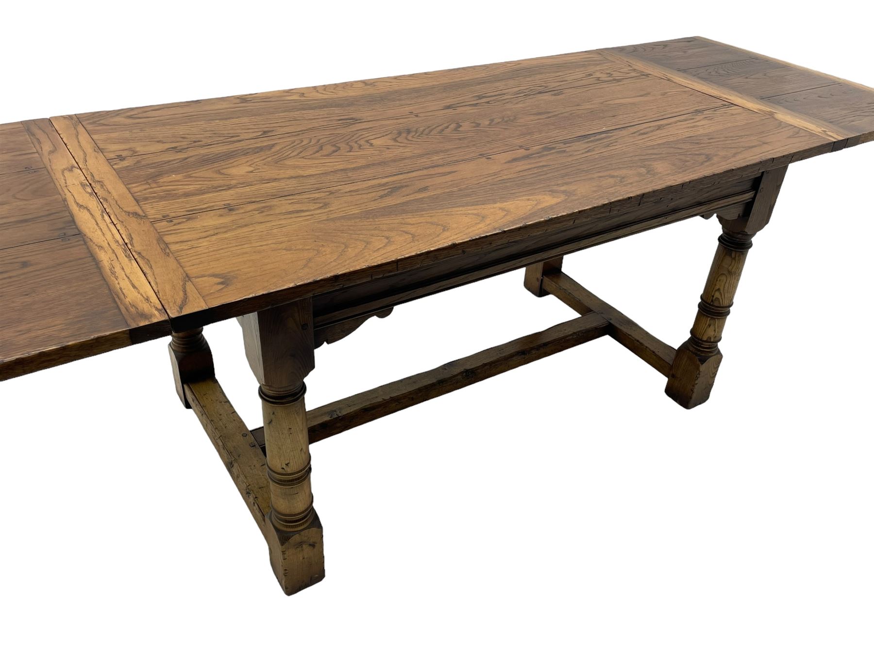 Oak refectory dining table, rectangular three plank top with cleated ends, two additional leaves, on turned supports united by H-stretchers 