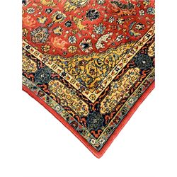 Persian design red ground rug, decorated with plant and animal motifs, the border decorated with floral design panels with guards