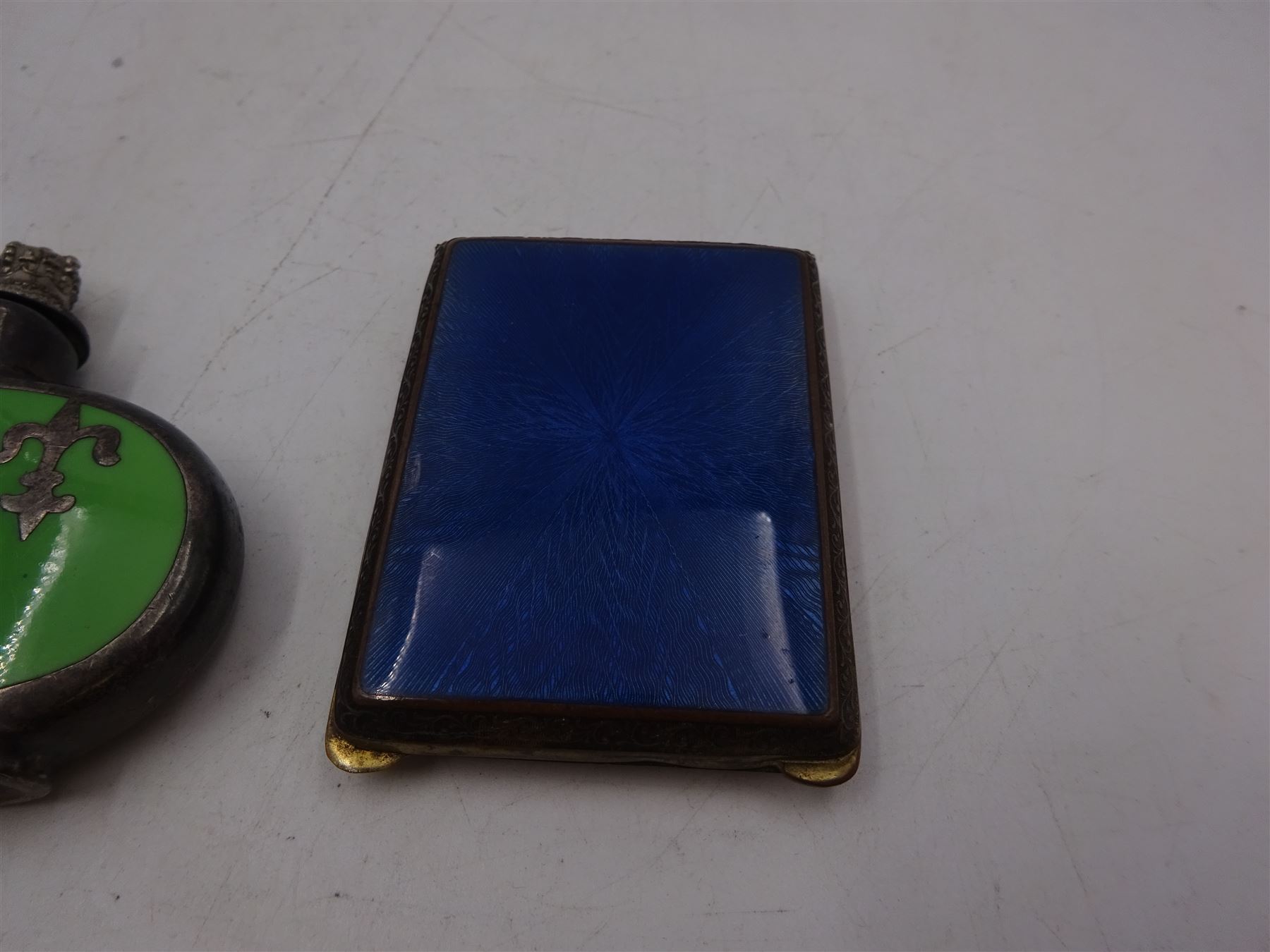 Early 20th century small brass cigarette case, with guilloche enamel panel to hinged cover, together with a silver plated ceramic scent bottle, cigarette case H6cm