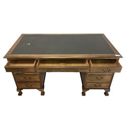 Georgian design twin pedestal desk, rectangular top with green leather inset, fitted with nine drawers, on cabriole supports with ball and claw feet 