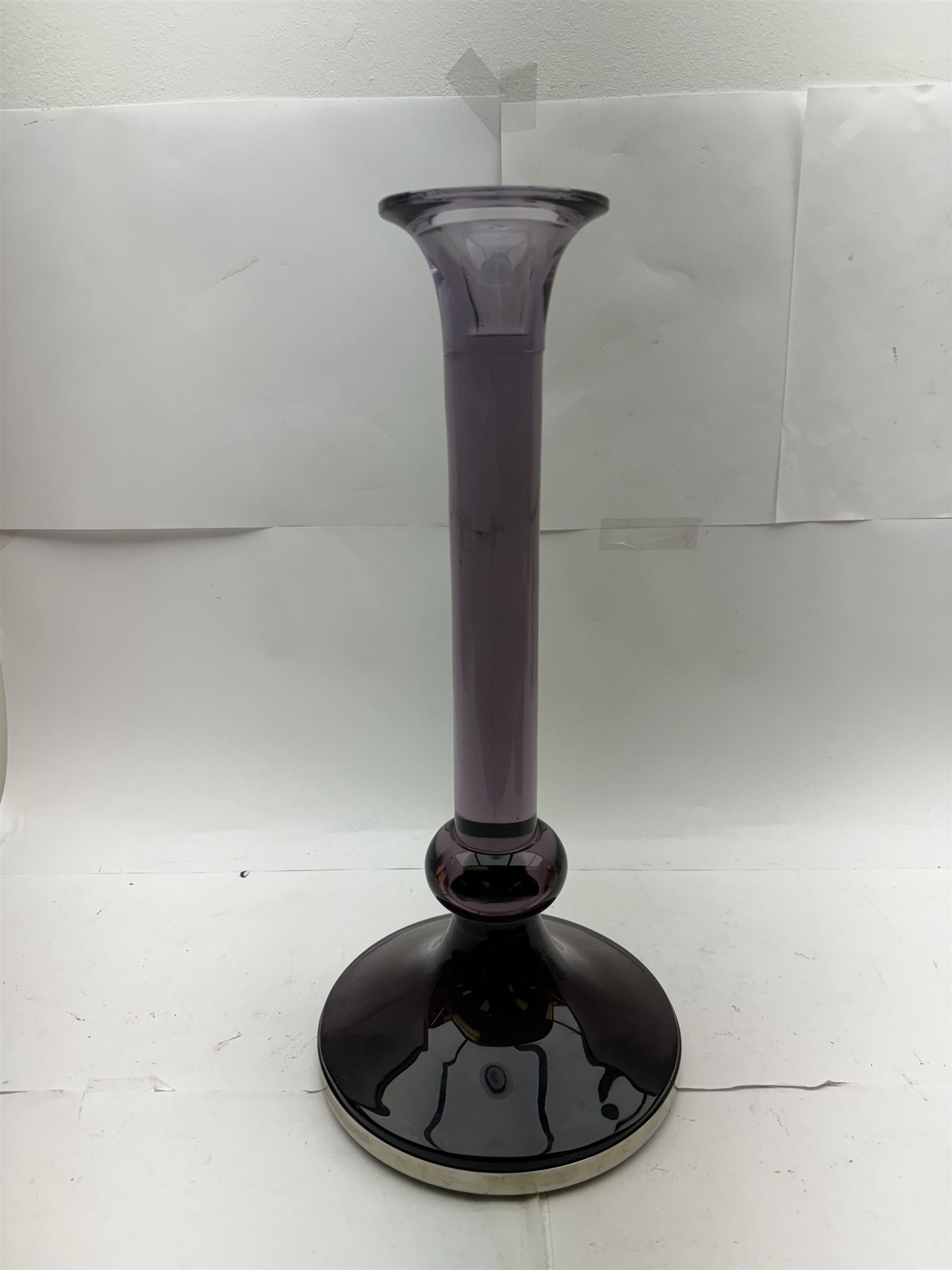 Large heavy gauge Scandinavian amethyst glass candlestick, the plain column with flared rim and basel knop, upon a spreading circular base, H44cm