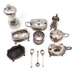 Group of silver cruet items, including two mustard pots, silver mounted pepper grinder, open salts, spoons, etc, all hallmarked 