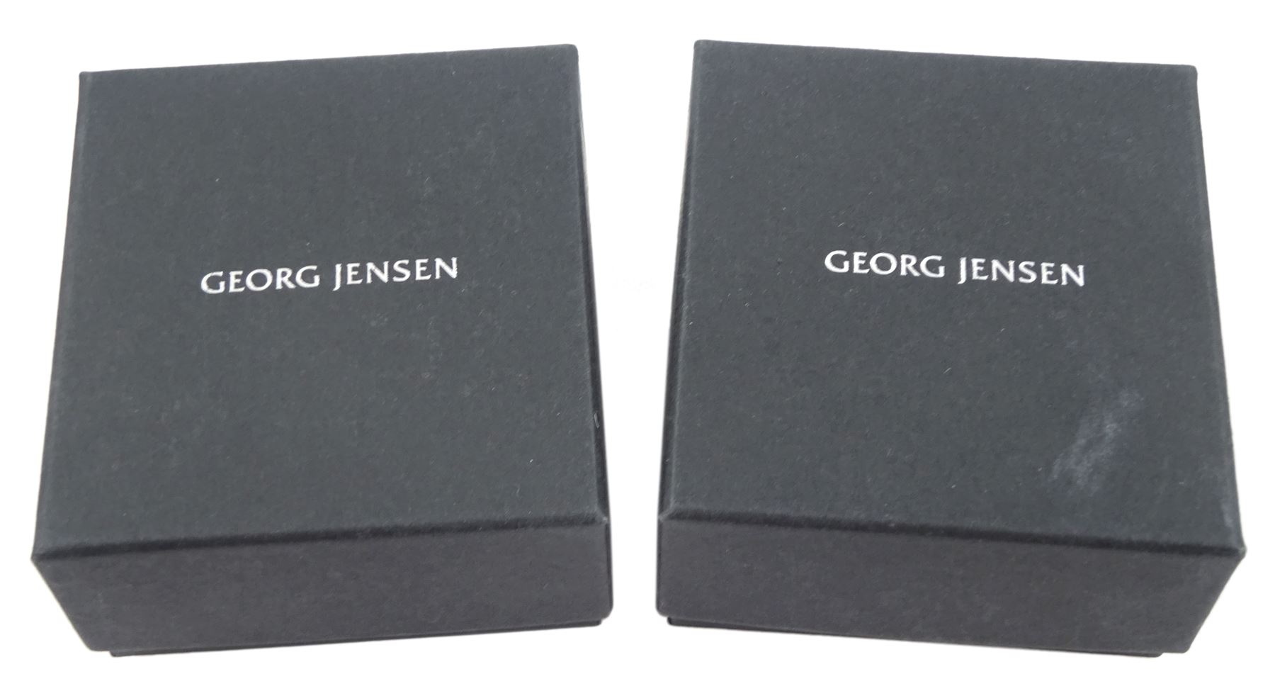 Pair of Georg Jensen Aria silver black onyx stud earrings, No. 612C and one other pair of Georg Jensen Infinity silver stud earrings