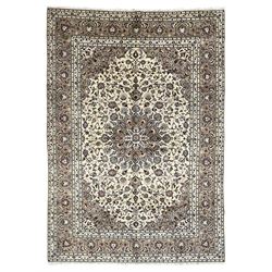 Persian Kashan ivory ground rug, central pointed rosette medallion surrounded by scrolling...