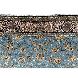 Persian Nain blue ground rug, overall arabesque design, the busy field decorated with interlacing branches and palmettes, indigo ground border with panels decorated with knots and lotus flower motifs, surrounded by trailing branches and flower heads, within guard stripes