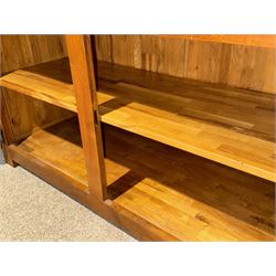 Large 20th century oak dresser, projecting cornice over open arched central section with two shelves, flanked by two panelled cupboards with two shelves, lower section with three drawers above three cupboards, on stile supports 