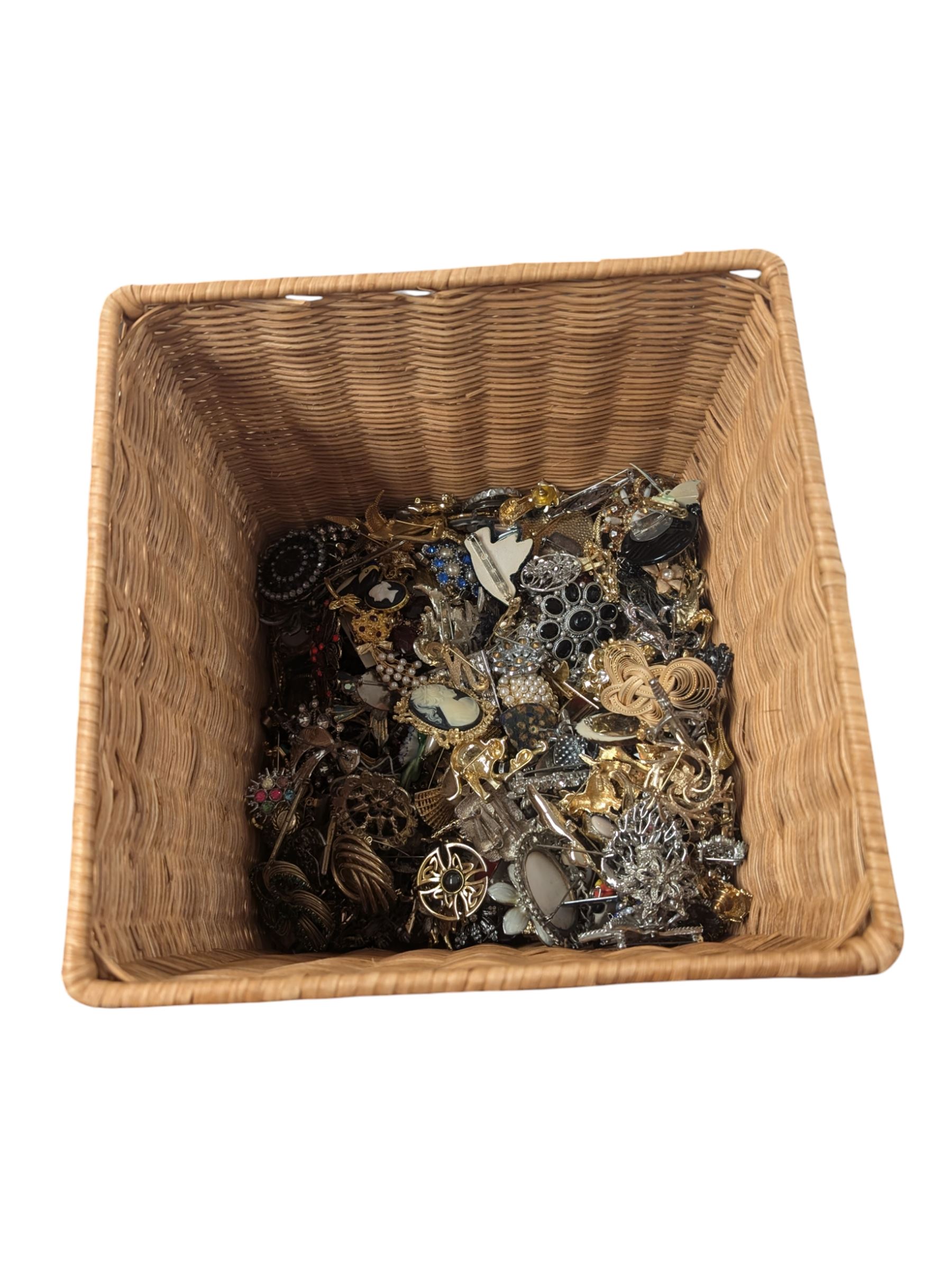 Collection of costume brooches, including ceramic, novelty and animal examples, contained within an wicker basket box