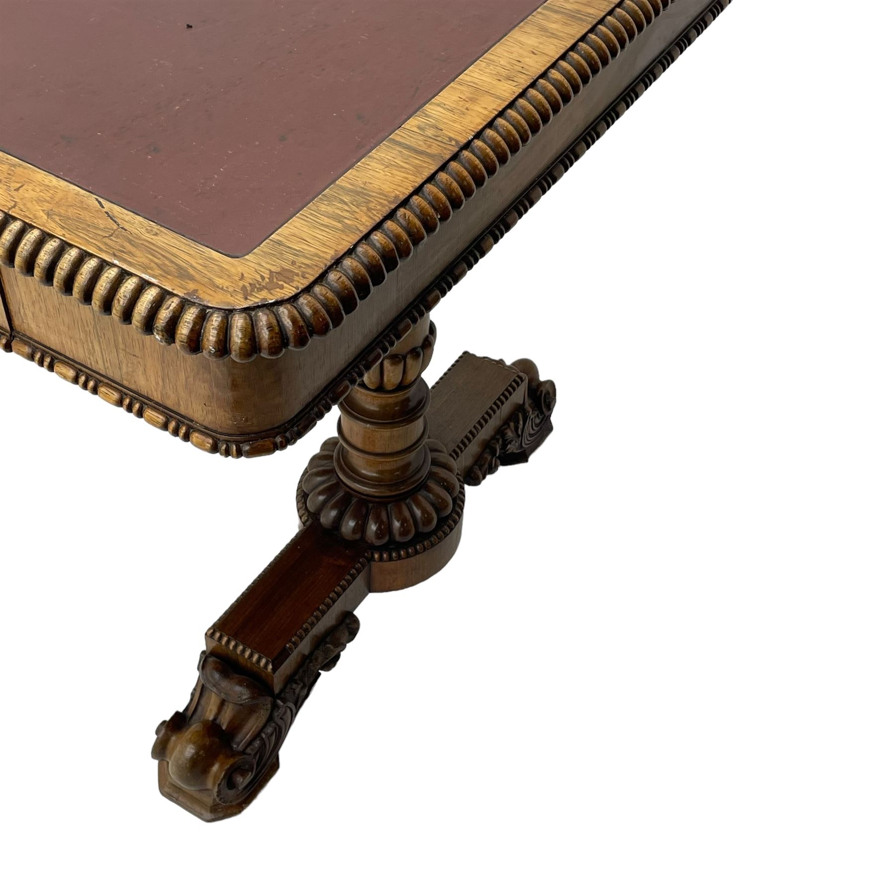 Early 19th century Regency rosewood writing table, rectangular top with inset leather writing surface and gadroon moulded edge, fitted with single frieze drawer, on twin turned pillar supports with lobe carved balusters, on platforms with beaded edge, acanthus scroll carved feet