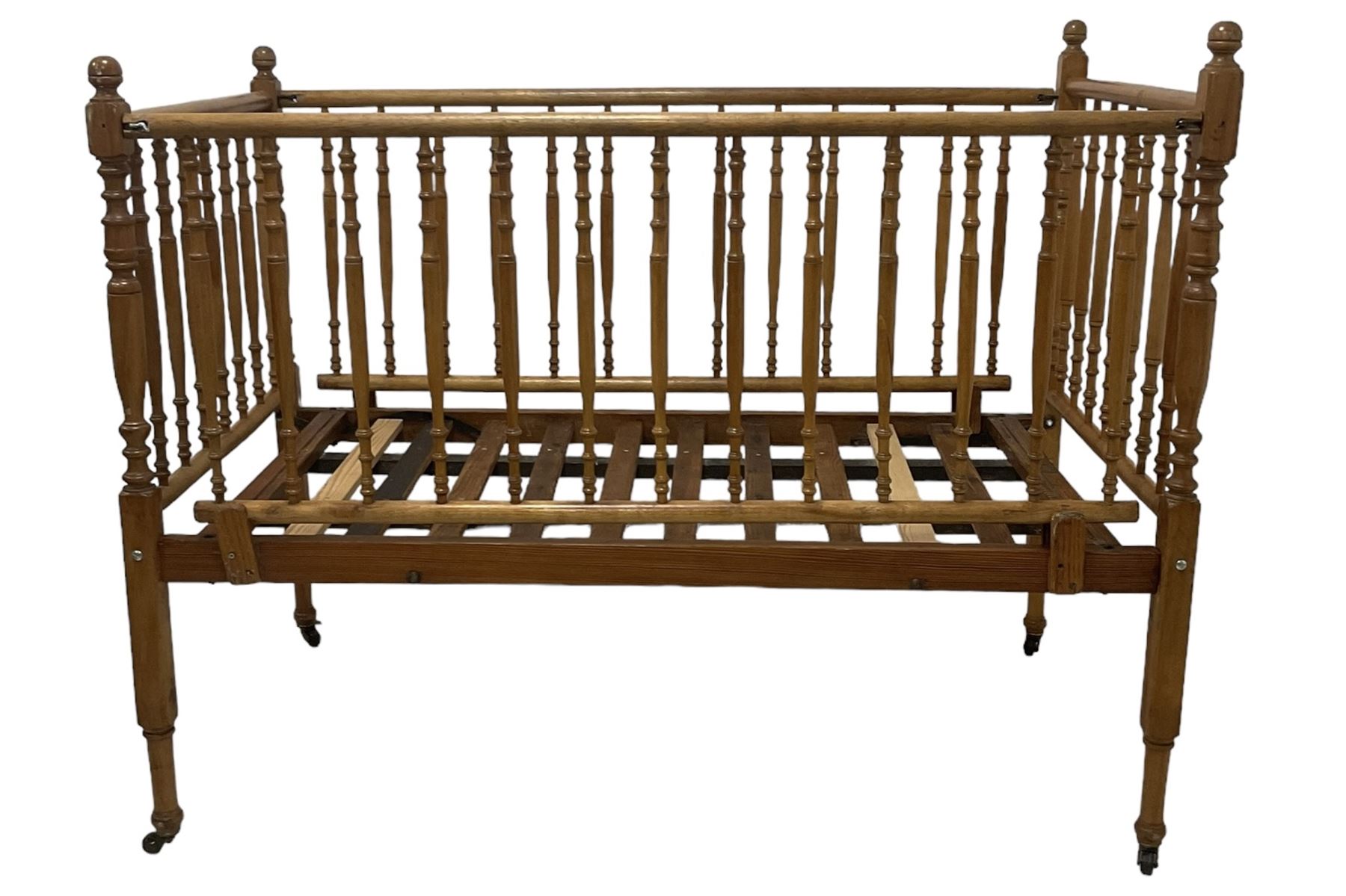 Victorian beech and pitch pine crib, turned spindle gallery supports, raised on square tapering supports with castors