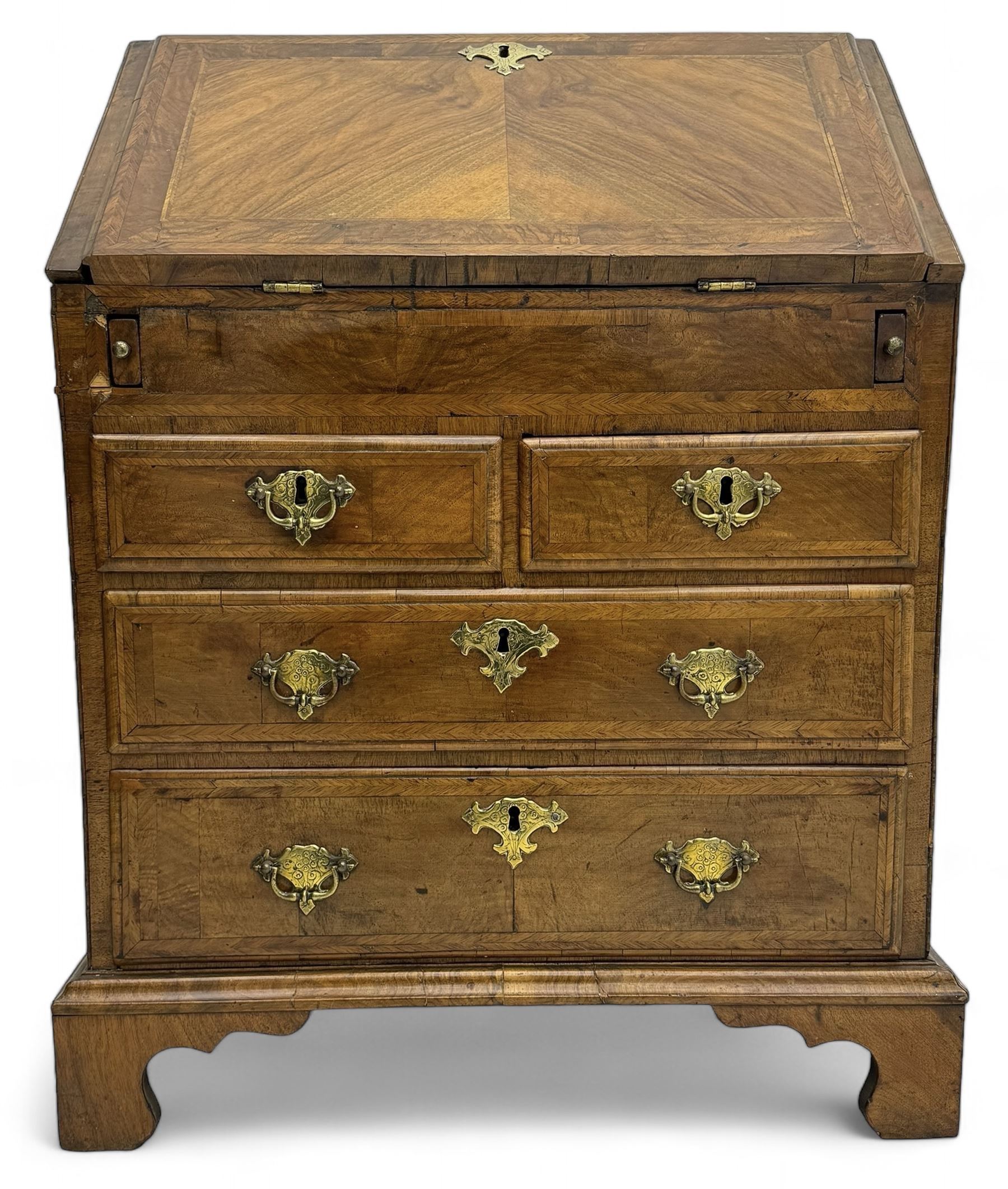 18th century walnut bureau, fall-front enclosing fitted interior with drawers and pigeonholes, over two short and two long drawers with brass escutcheon plates and handles, raised on bracket feet