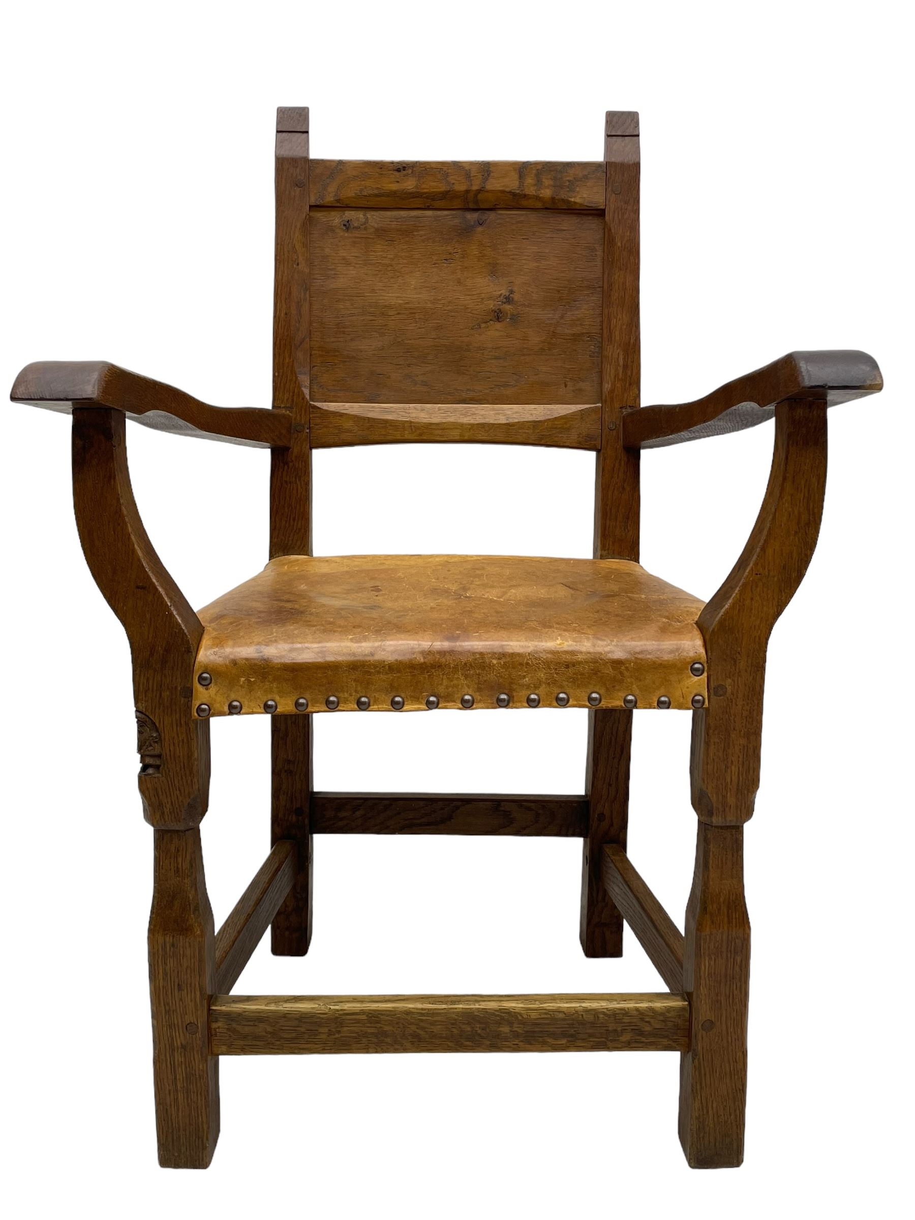 Gnomeman - set of eight (6+2) oak dining chairs, adzed panelled back over tan leather upholstered seat with applied stud band, on square supports united by plain stretchers, each chair carved with gnome signature, by Thomas Whittaker, Littlebeck, Whitby